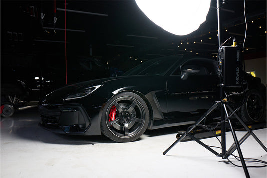 A photo of behind the scenes of a car with big brakes